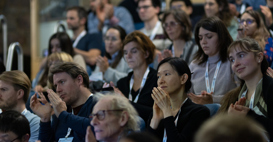 Audience at a Biochemical Society meeting applauding speaker