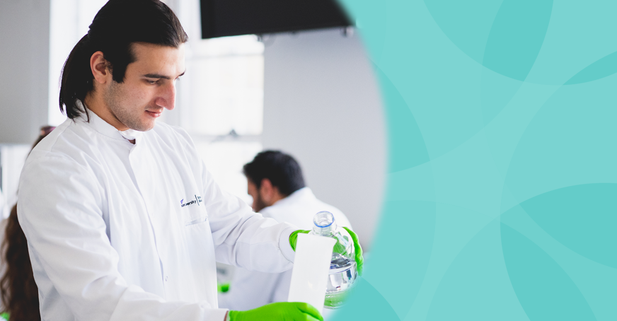 Undergraduate member pouring solution into a measuring cylinder