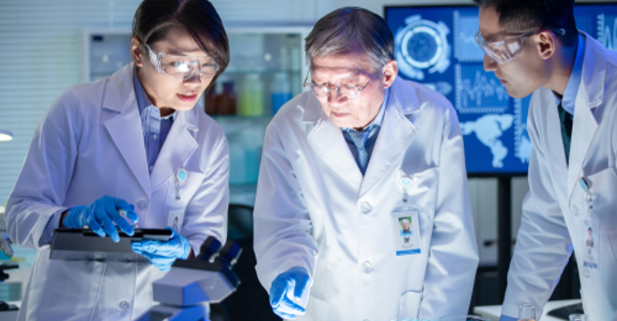 Three biochemists collaborating in a laboratory
