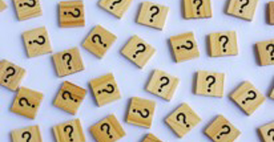 small scrabble tiles with question marks on them