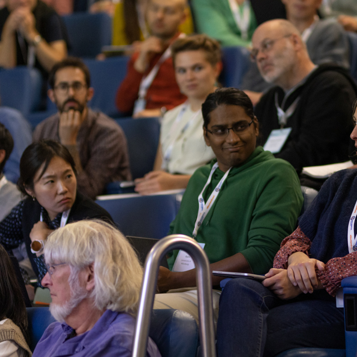 Image shows a member asking a question in an audience