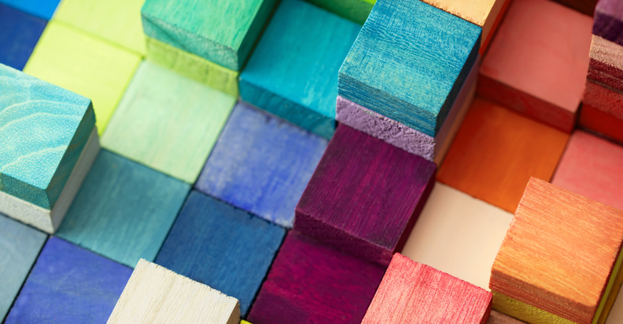 Multicoloured wooden blocks stacked on top of each other.