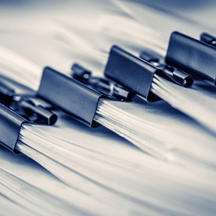 First image depicts a pile of reports. Second image shows people reading reports