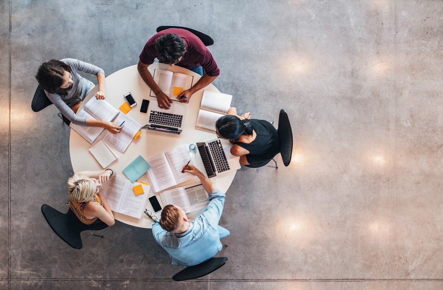 Birds-eye view of a committee sat around a table