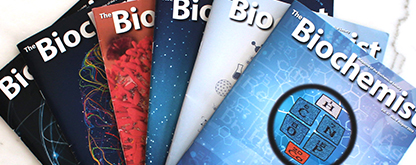 Front cover of multiple issues of The Biochemist magazine in a fan shape.