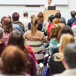 Classroom full of students with an educator addressing them
