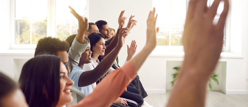 Group of people raising their hands