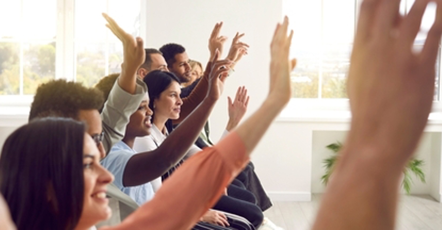 Group of delegates with their hands up
