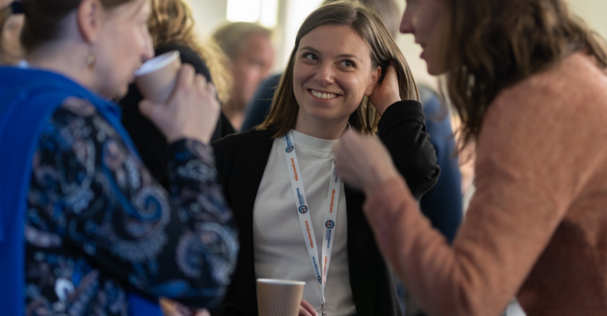 Smiling women networking at a conference