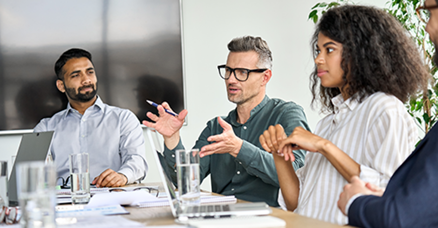 three people around a board table