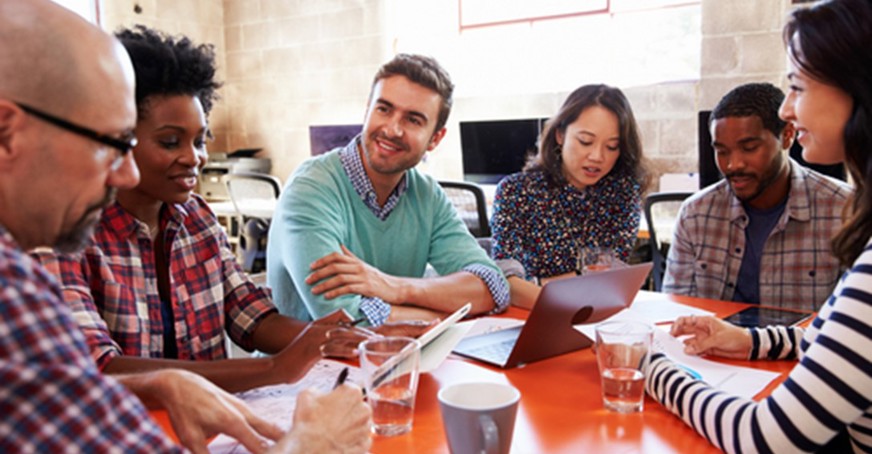 Group of people talking around a table