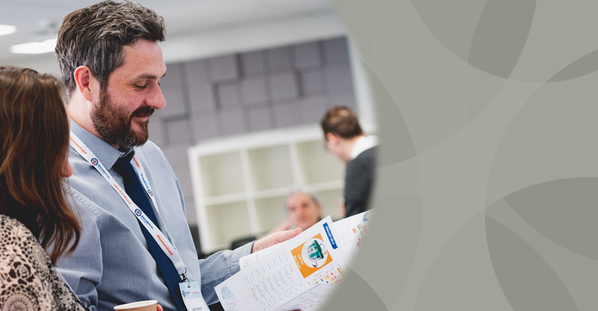 Associate member showing another member some documents