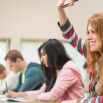 Student with their hand up in class