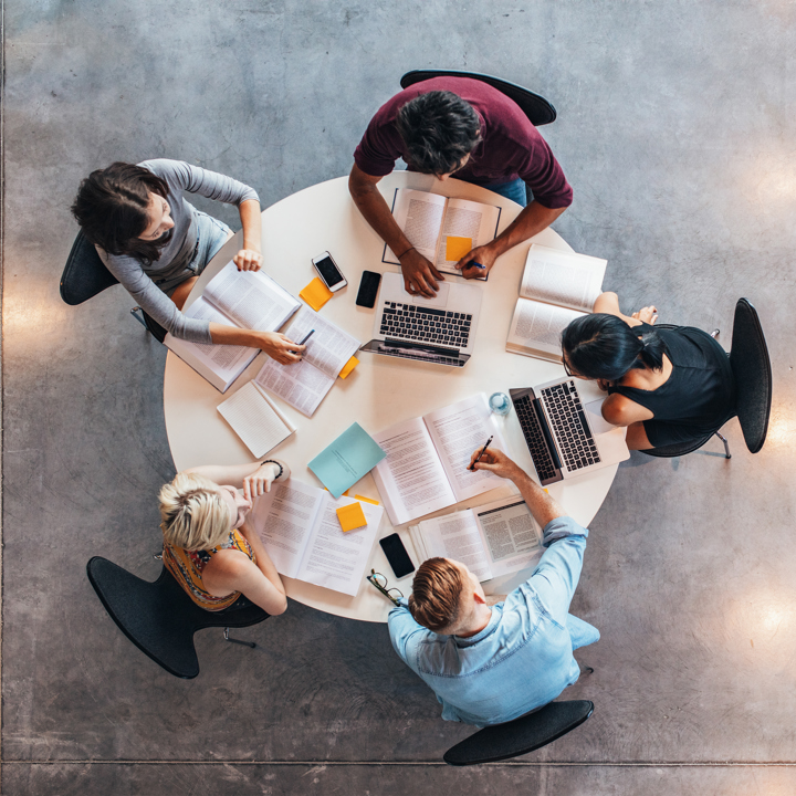 Panel members assembled around a table, viewed from above