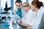 Group of 3 scientists in a lab conducting research