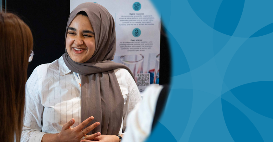 Postgraduate member presenting a poster at a conference