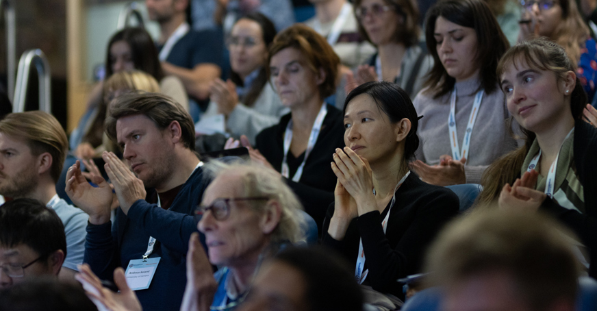 Group of delegates clapping during a conference