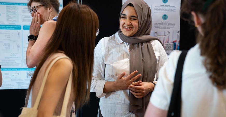 Postgraduate member presenting a poster at a conference