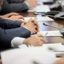 Photo of group of people working as a team with hands in the centre