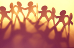 Paper doll people holding hands