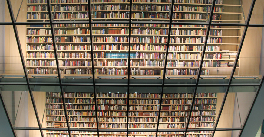 Floor to ceiling wall of books in a modern library setting