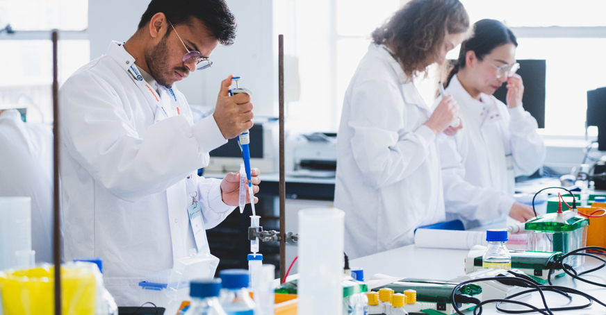 Undergraduate member pipetting into a tube