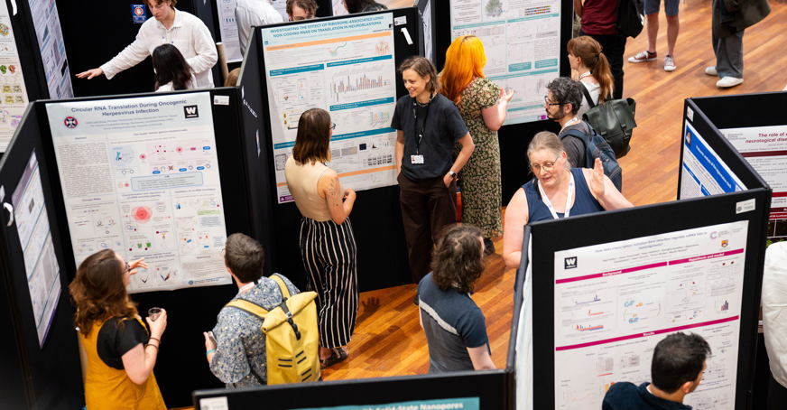 Group photo of members at a poster session at Translation UK