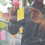 Post-notes with people writing on them