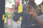 Post-notes with people writing on them