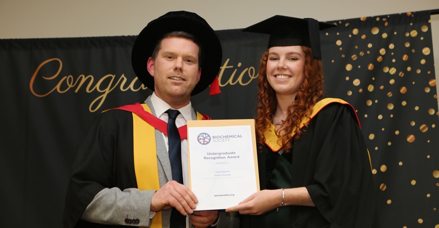 Undergraduate receiving their certificate at graduation