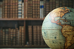 World globe against a backdrop of old books