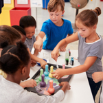 Group of children getting involved with an experiment with an educator
