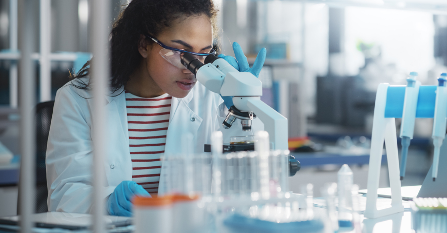 Scientist looking through a microscope