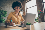 A woman sat at her laptop doing online training