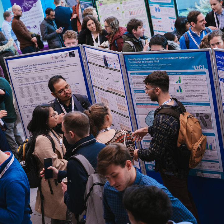 Meeting delegates networking at a scientific poster session and a smaller secondary image of a scientist handling a petri dish.