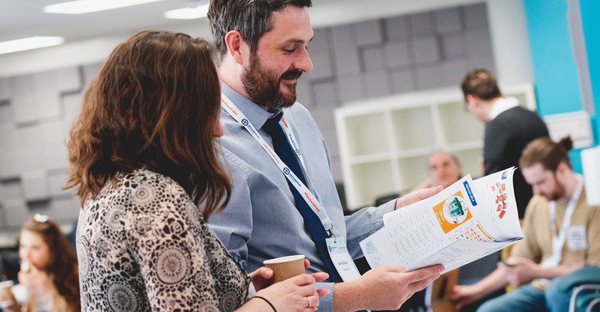 Associate member showing another member some documents