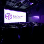 Empty conference room with the Biochemical Society logo on the screen
